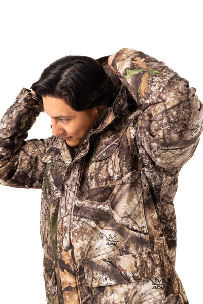 Model adjusting hood on men’s Realtree APX camouflage jacket.