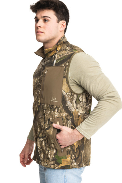 Men’s fleece camo vest in Realtree APX, angled side view highlighting fit and arm openings.