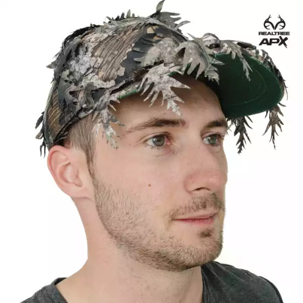 A Realtree APX QuikCamo leafy ball cap is shown worn as a standard hat with 3D leaf detailing along the brim and crown.