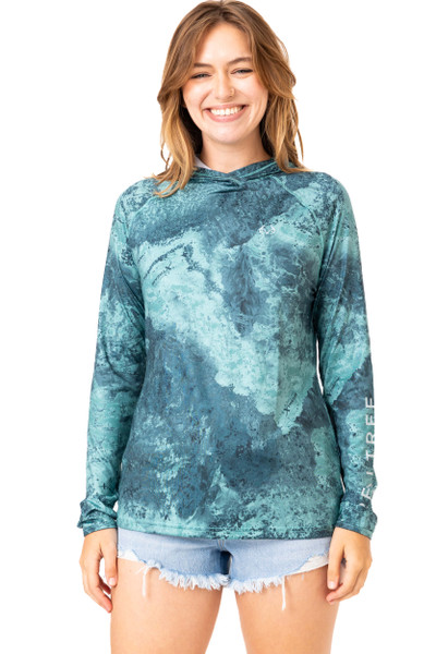 Front view of a woman wearing the Realtree Fishing Women’s XTREME Emerald Green Hooded Shirt, showing the water-patterned design and long sleeves main.