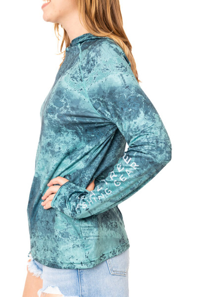 Side view of a woman wearing the Realtree Fishing Women’s XTREME Emerald Green Hooded Shirt, showing long sleeves and side seam details.