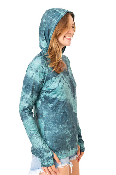 Side view of the Realtree Fishing Women’s XTREME Emerald Green Hooded Shirt with the hood worn up, displaying the pattern and fit.