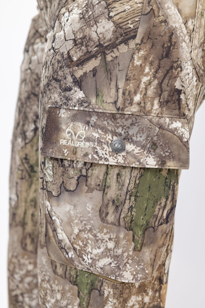 Detailed view of Realtree sleeve with button-flap pocket and embroidered logo, set against bark-textured camouflage fabric.