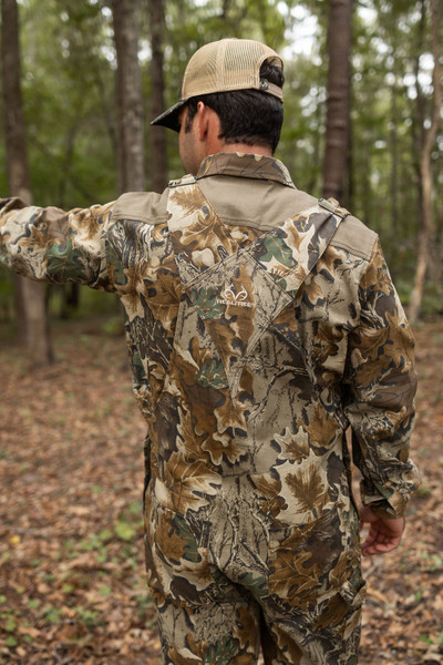 Back view of Realtree Advantage Classic hunting bib overalls, showing the crossed strap design and full camo coverage.