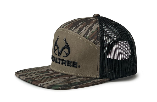 Side view of a tan and SA7AGE camo trucker hat with a black Realtree antler logo on the front and black mesh back main.