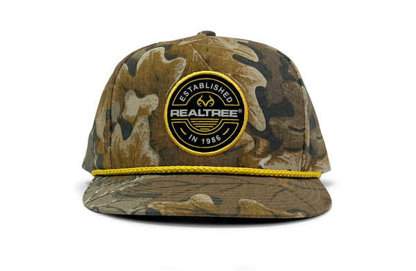 Front view of a micro-suede camo rope hat with a Realtree Established patch and yellow rope across the brim.