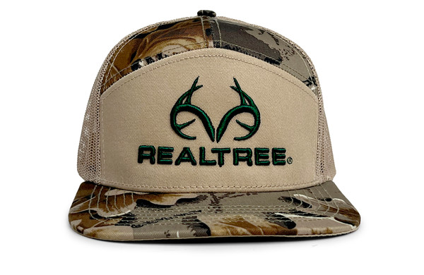 Front view of a tan mesh-back trucker hat with a Realtree antler logo embroidered in green and a Realtree Advantage Classic camo bill main.