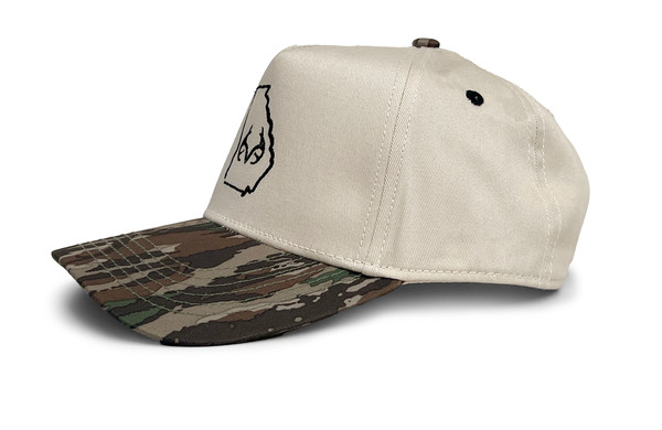 Side view of the cream hybrid cap showing the structured crown and Realtree Original camo bill detail.