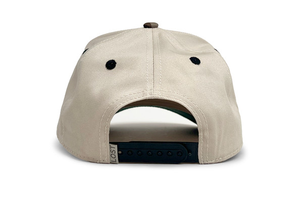 Back view of the cream hybrid cap with adjustable snapback closure and contrasting black eyelets.