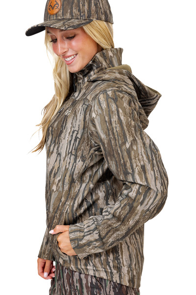 Side view of the Realtree Legacy camo hunting jacket with hood up, highlighting pocket placement and shoulder seams.