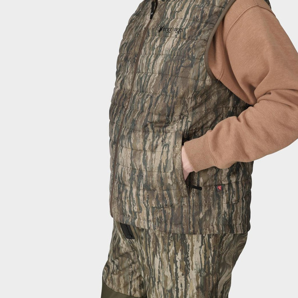 Side close-up of Realtree Legacy camo vest highlighting insulated quilting and hand pocket.