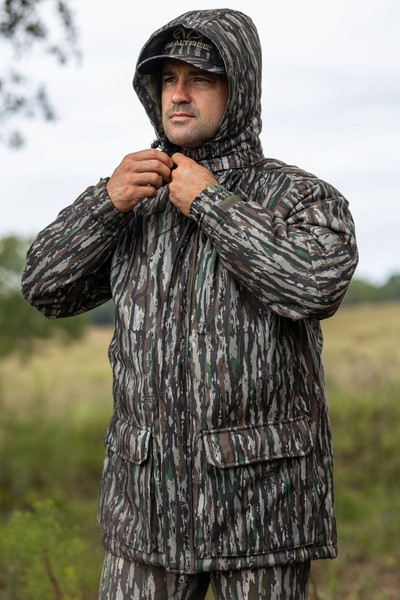 Pro Staff Insulated Water Resistant Parka in Realtree Original shown outdoors with hood up, emphasizing water-resistant material and classic Realtree pattern.