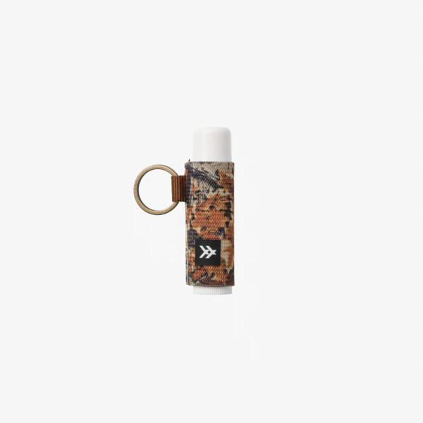 Side view of Thread Realtree Advantage Classic lip balm holder showing compact cylindrical design and key ring loop.