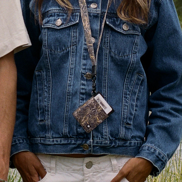 Thread Realtree MAX-7 camo vertical wallet worn on lanyard with denim jacket for everyday carry.