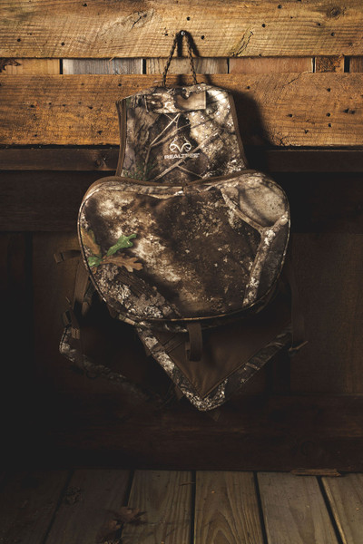 Spring Thunder Turkey Vest hanging on wood backdrop, front view with large seat cushion.