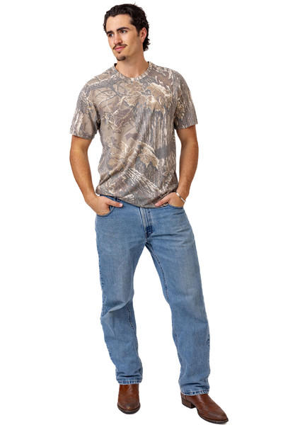 Full-body view of men’s Realtree Xtra Grey camo short sleeve shirt styled with jeans.