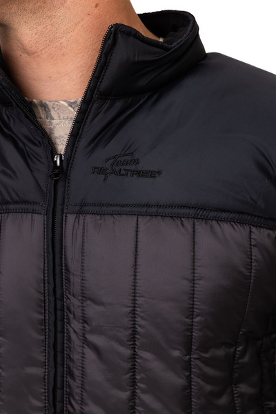 Close-up of Team Realtree logo on Men's Realtree 40th Anniversary Pro Staff Black Puff Jacket.