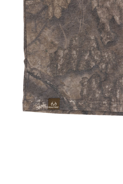 Close-up of camo fabric detail with Realtree logo hem tag.