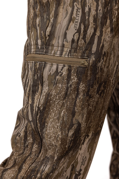 Close-up of zippered thigh pocket detail on Realtree Legacy camo pants.