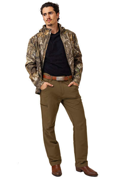 Full-body view of men’s Realtree Brown pants styled with belt and outdoor jacket.