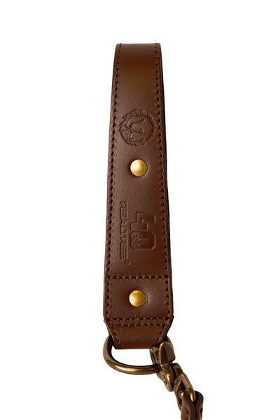 Close-up of the Wren & Ivy Turkey Tote featuring embossed leather, brass rivets, and Realtree 40th Anniversary branding.