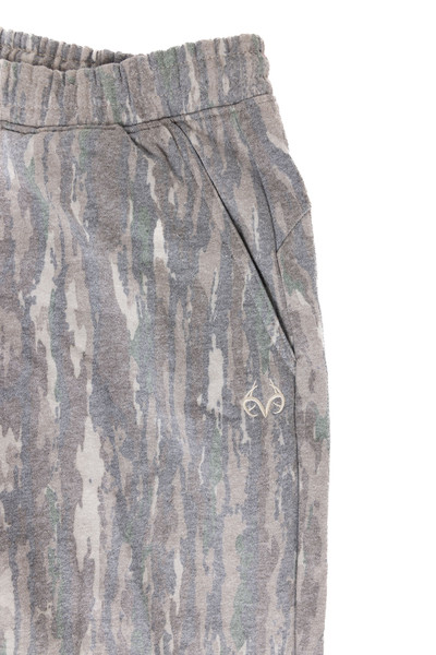 Close-up of elastic waistband and side pocket on Realtree Original camo sweatpants.