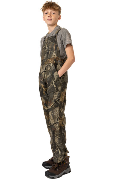 Angled front view of youth camo bib overalls showing fit and full-length design.