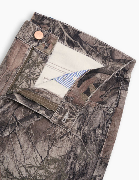 Detail of Mugsy camo denim jeans waistband, button, and zipper closure.