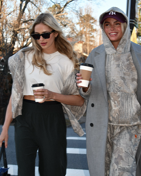Two women wearing Banded Realtree Xtra Grey camo hoodie styled casually.