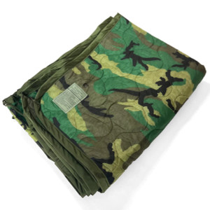 Folded US military woodland camo poncho liner (woobie) with quilted stitching and olive trim Folded US military woodland camo poncho liner (woobie) with quilted stitching and olive trim