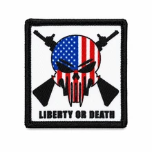 Liberty Or Death embroidered morale patch featuring an American flag skull with crossed rifles and hook and loop backing.