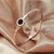Korean version of the 18k rose gold opening black shell titanium steel Roman numerals bracelet female versatile do not lose color jewelry bracelet Korean version of the 18k rose gold opening black shell titanium steel Roman numerals bracelet female versatile do not lose color jewelry bracelet