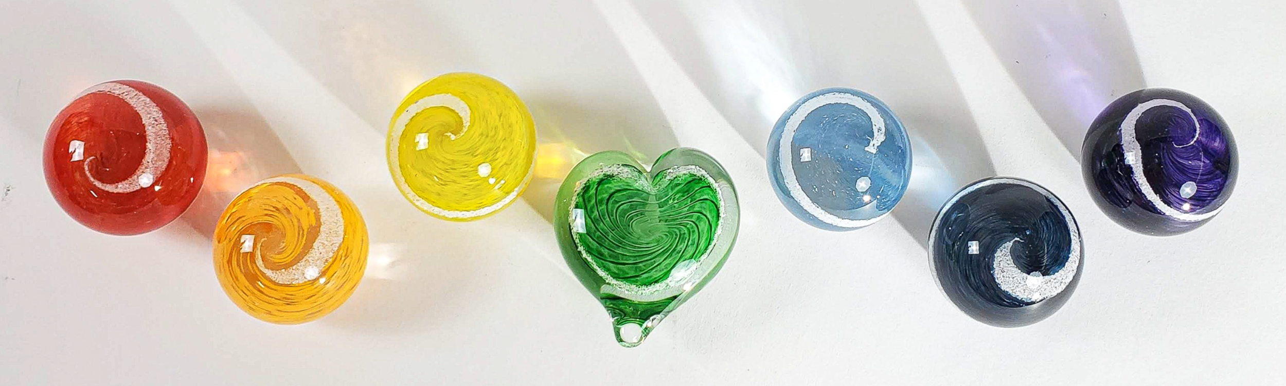 Colorful cremation hearts and cremation orbs 