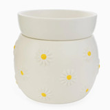 A white ceramic wax warmer with a rounded body featuring embossed white daisy flowers with yellow centers and a matching removable top dish