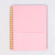 Open spiral notebook showing a pink pocket divider