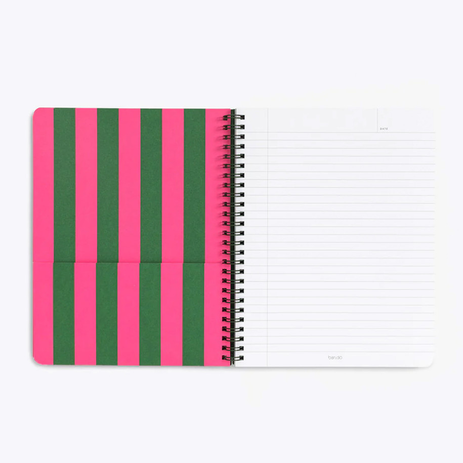 Open notebook showing a pink and green striped pocket divider and a white lined page with a date header
