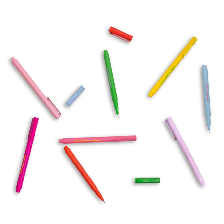 Flat lay of assorted colorful markers and detached caps scattered on a white background, showing fine felt tips.