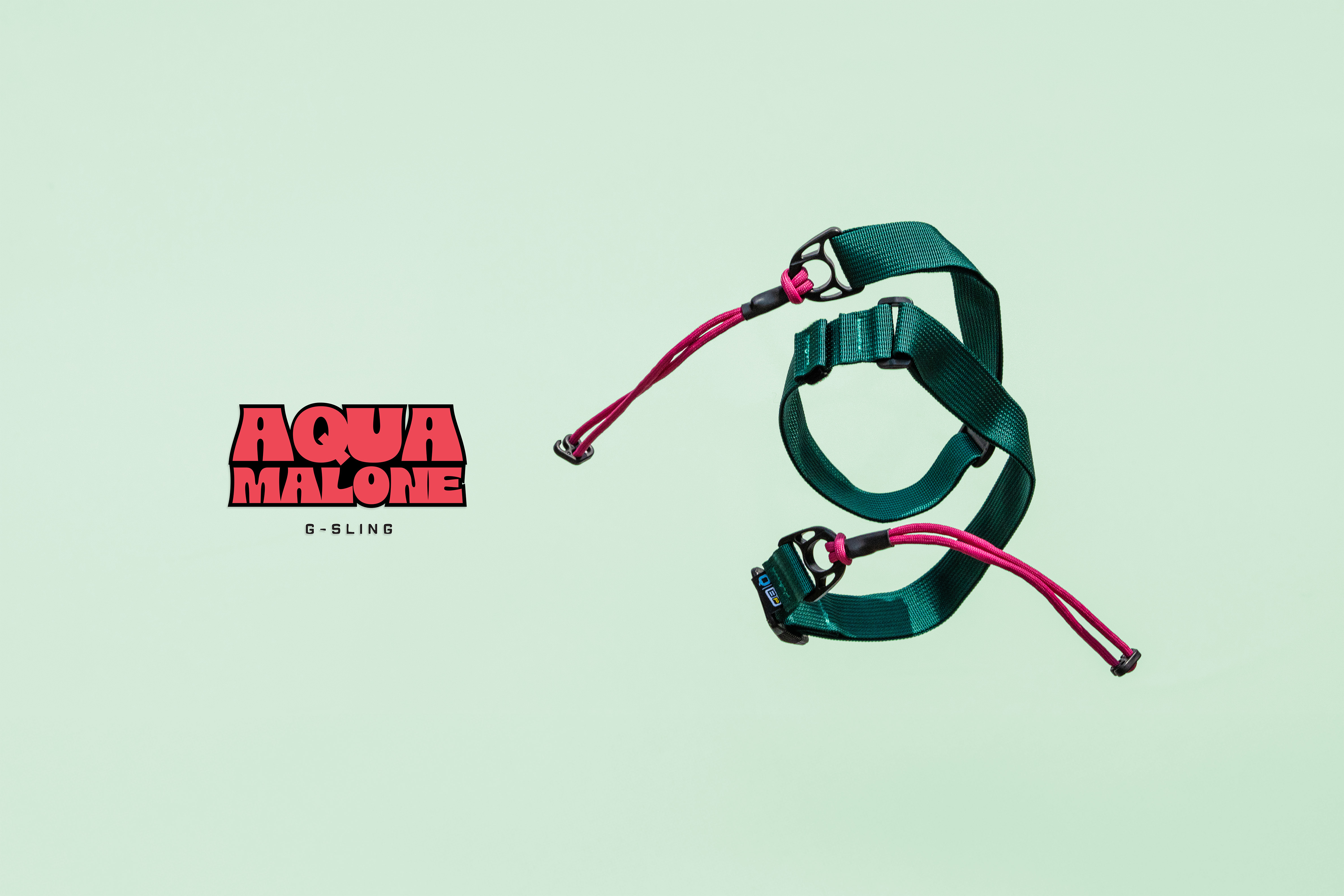 Green and pink Aqua Malone G-Sling displayed on a light mint background with the Aqua Malone logo on the left.