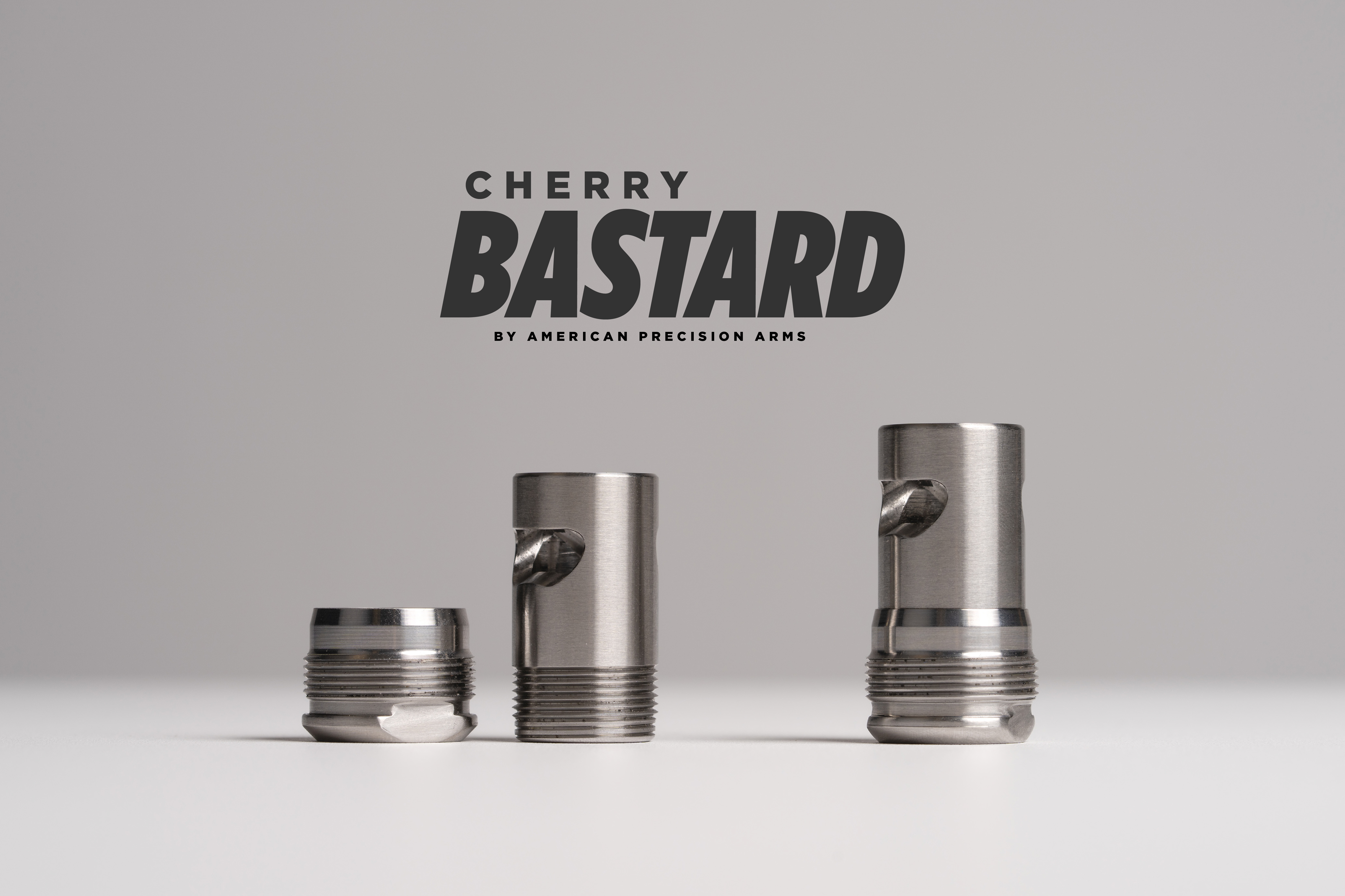 Cherry Bastard muzzle brake by American Precision Arms disassembled on white background
