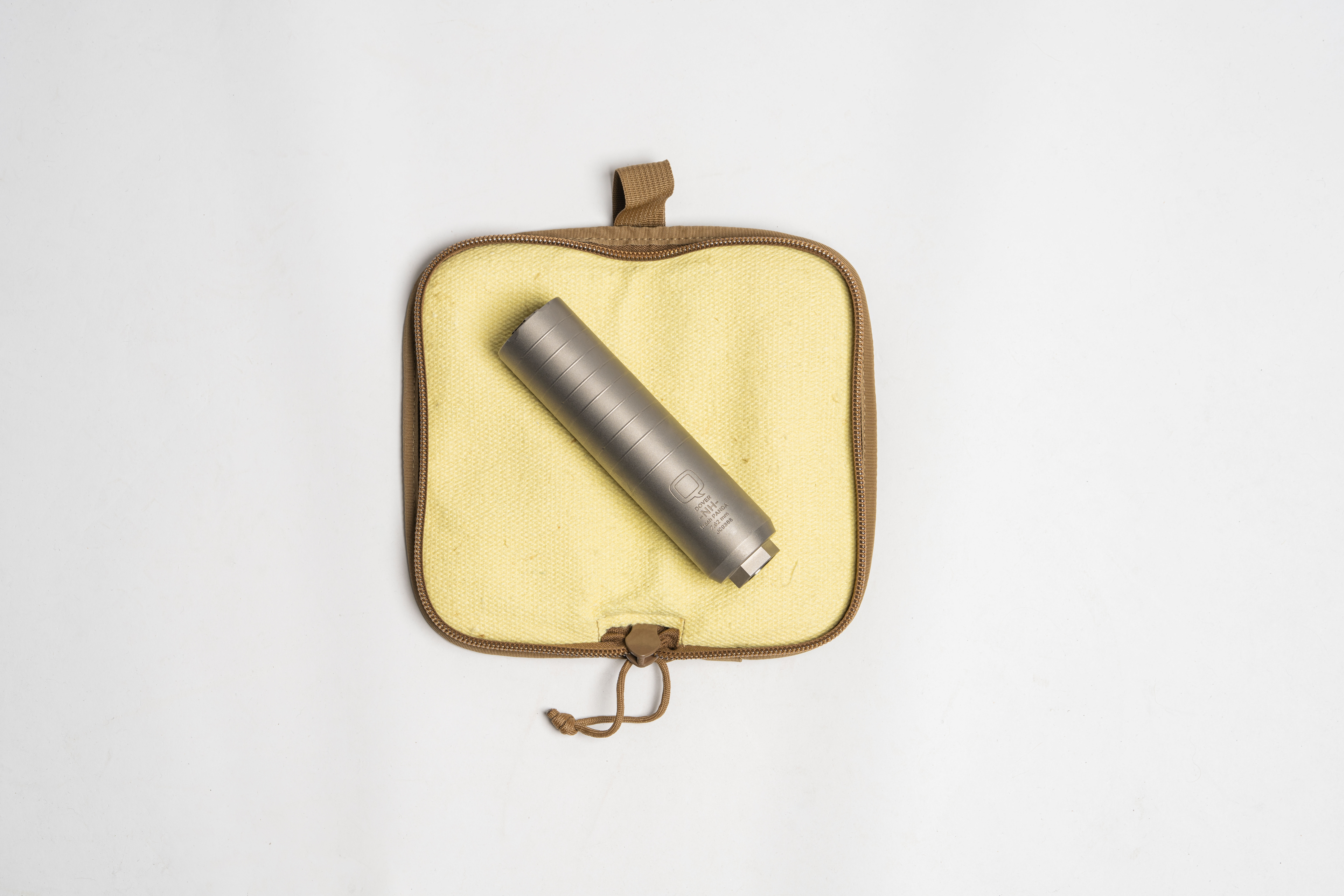 Tan silencer pouch open with silencer inside, on white background