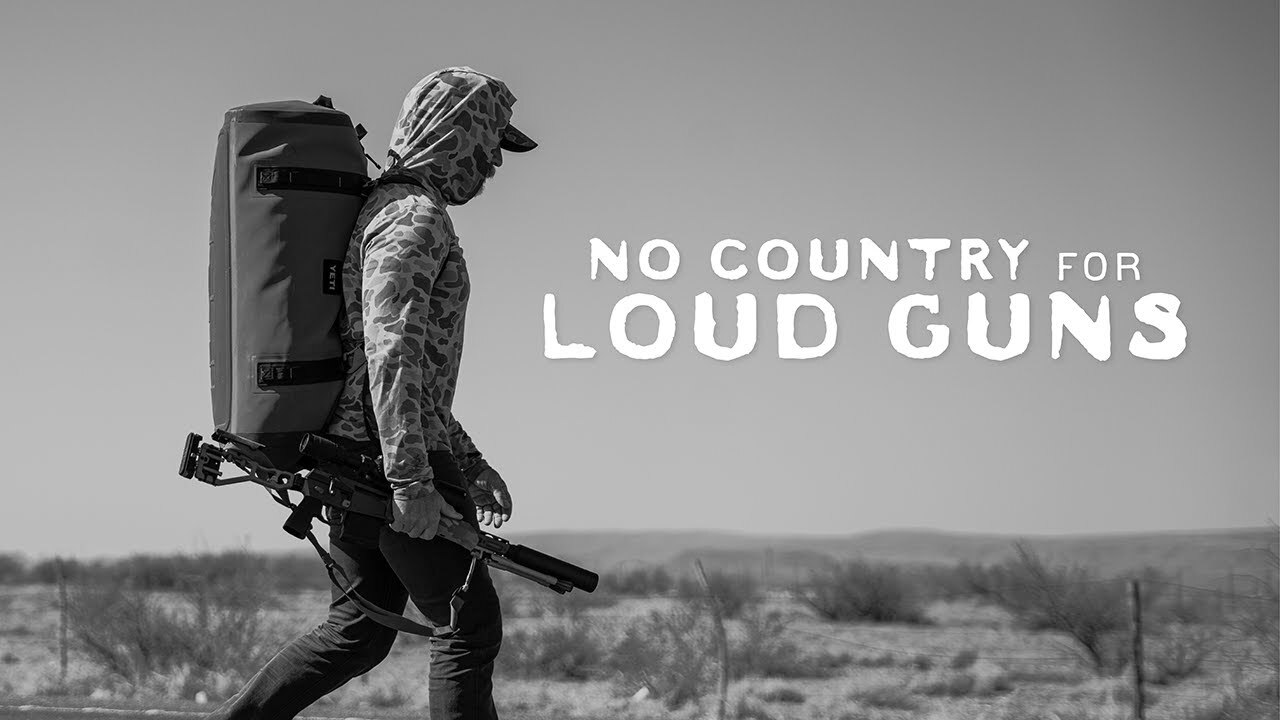 Black and White Image of man walking with rifle and bag.