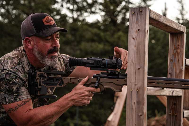 Tactical shooter using a mounted  Ocelot 640 Thermal Imaging Scope close-up of controls and side angled profile. PARD Ocelot Thermal Imaging Scope front view showing circular display and lens. PARD Ocelot Thermal Scope side view highlighting 100mm eye relief and aluminum housing. PARD Ocelot Thermal Imaging Scope close-up of controls and side profile. Ocelot Thermal Imaging Scope.