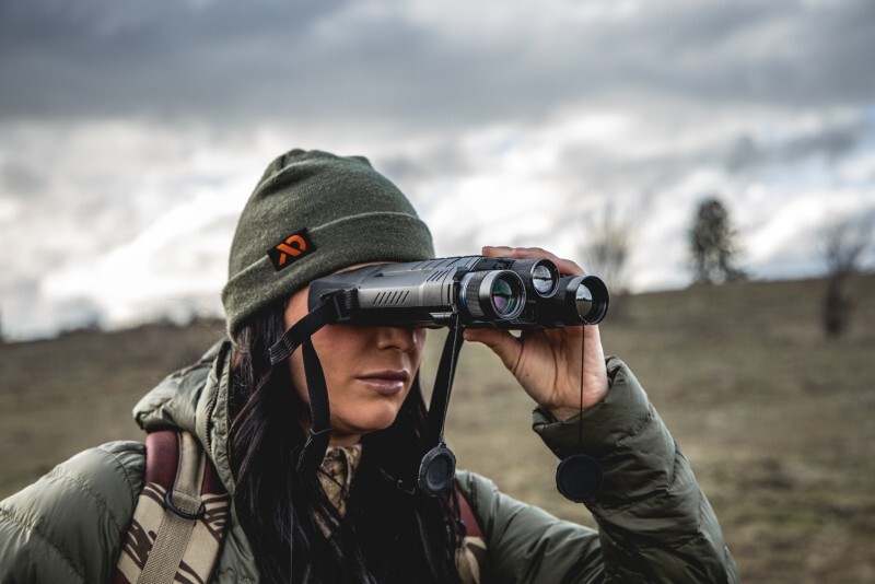 Hunter holding PARD Osprey Multi-Spectral Binoculars.