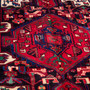 Nahavand Persian Rug 9'6" x 5'3" - Semi Antique Medallion Navy Blue, Red Hand Knotted | side view | SKU 112295