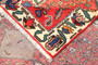 Bakhtiari Persian Rug 9x4 ft - Semi Antique Medallion Toranj Geometric Madder Red Cream Navy Blue Hand Knotted | side view | SKU 111538
