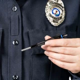 ASP Blue Line Clip Handcuff Key, Held in Police Officer's Hand