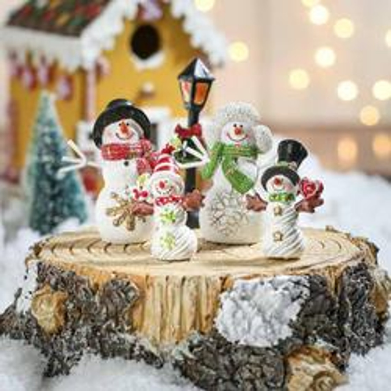 Snowman Family on Tree Trunk