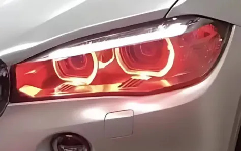 Illuminated headlights of a BMW F15 with a distinctive design.