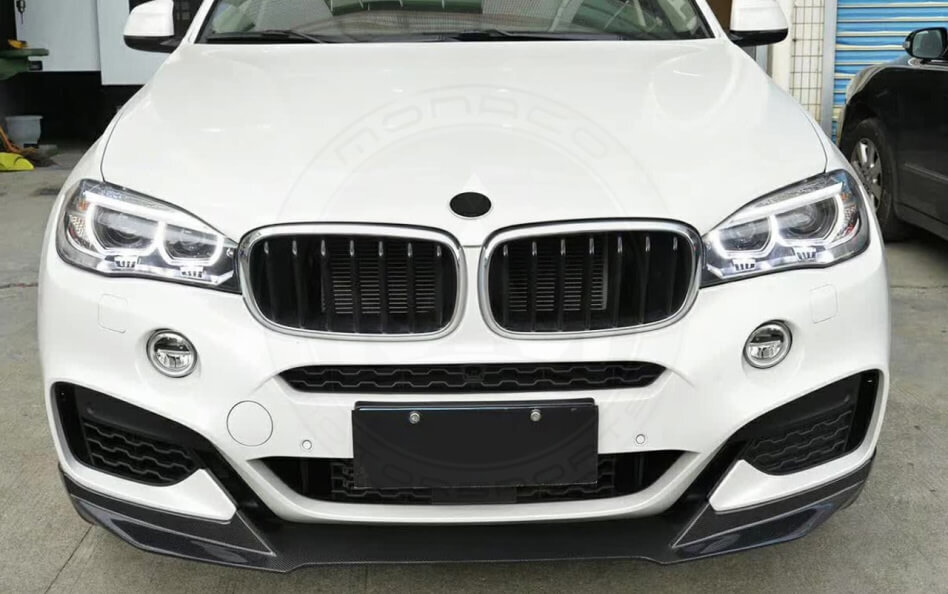 Front view of a white BMW SUV with signature kidney grille and LED headlights.