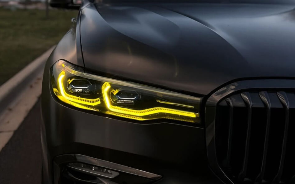 Close-up of illuminated LED headlight on a BMW X7.